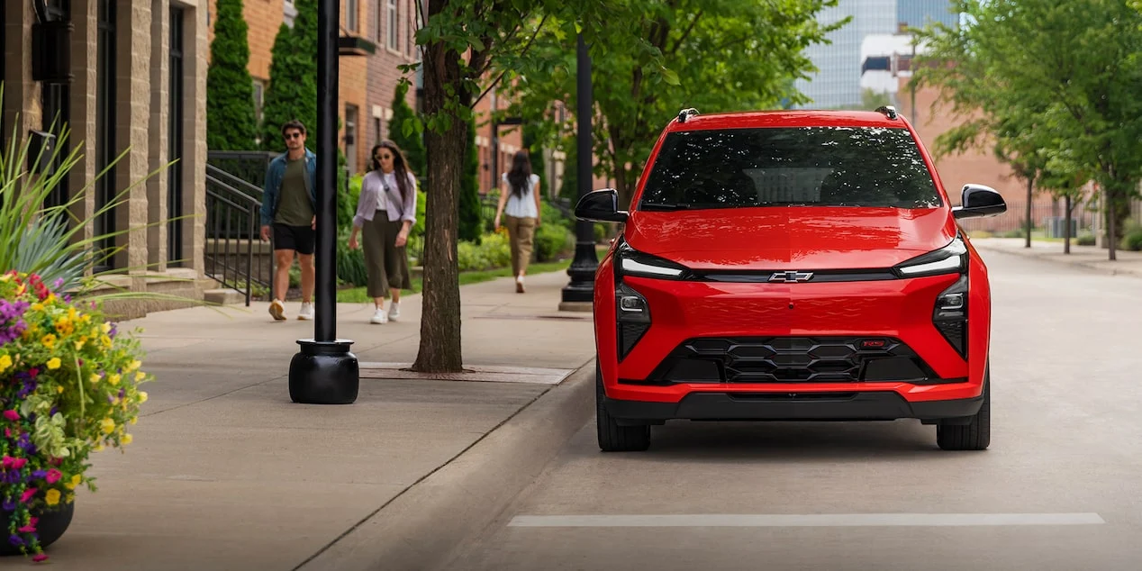 Red Chevrolet Bolt shown from the front on a city street